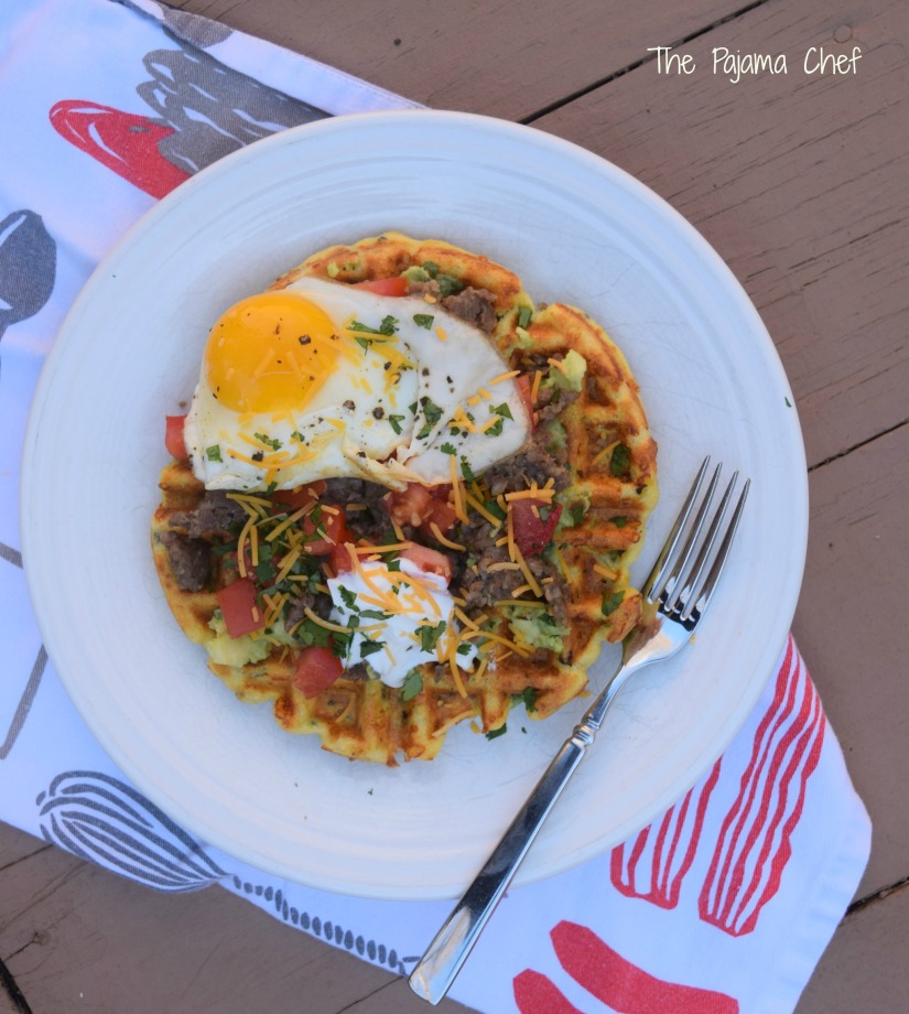 Cornbread waffles filled with cheese, peppers, and onions are loaded with sausage, tomatoes, a creamy avocado spread, and a fried egg for an impressive brunch like no other! This is a fantastic restaurant-worthy dish that's easy to make at home. You'll be sure to love it! #secretrecipeclub